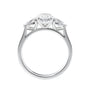 Oval natural diamond 3 stone engagement ring with pear shaped side stones white gold side view.