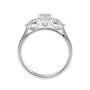 Emerald and pear cut natural diamond trilogy engagement ring white gold side view.