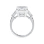 Emerald cut natural diamond engagement ring with tapered baguette shoulders white gold side view.