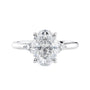 Lab grown oval diamond engagement ring with trilogy diamond set shoulders 18ct white gold front view.