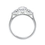 Round and pear three stone natural diamond engagement ring in white gold side view.